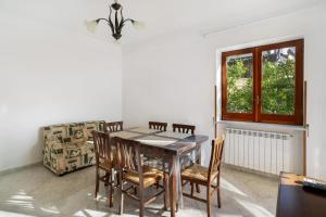 a dining room with a table and chairs and a window at La Vista Sul Golfo in Massa Lubrense