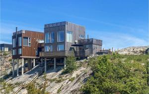 a house on top of a hill on a cliff at Cozy Home In Søndeled With Kitchen in Søndeled