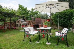 two chairs and a table with an umbrella at Apartment Miriam in Ika +52 photos