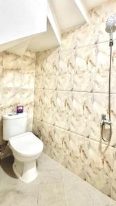 a bathroom with a toilet and a shower at The Villas in Bogor +49 photos