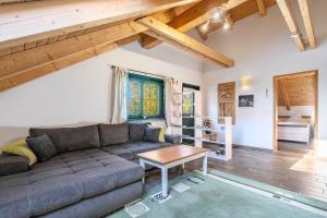 a living room with a couch and a table at Blockhaus - Ferienwohnung Sunset in Erdmannsdorf