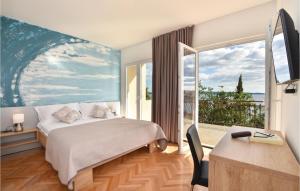 a bedroom with a bed and a large window at Amazing Home In Okrug Gornji in Trogir