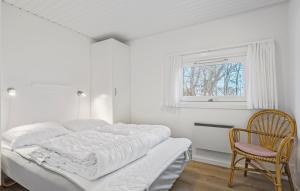 a white bedroom with a bed and a chair at 3 Bedroom Lovely Home In Bjert in Binderup Strand