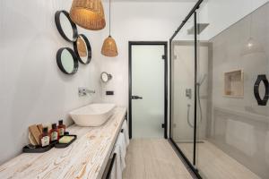 a bathroom with a sink and a shower at Ölüdeniz Blu Luxury Unique Hotel - Adults-Only in Oludeniz