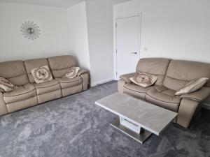 a living room with a couch and a coffee table at Stratford Way House in Northfleet