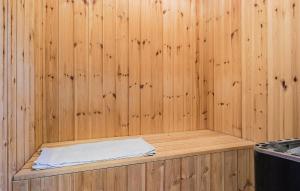 a wooden sauna with a white towel in it at 4 Bedroom Nice Home In Gråsten in Gråsten