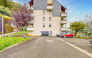 a building with a car parked in a parking lot at Pet Friendly Apartment in Bagnères-de-Bigorre +9 photos