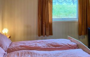 a bedroom with a bed and a window at 5 Bedroom Gorgeous Home In Hundeidvik in Hundeidvik
