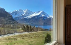 a window with a view of a snow covered mountain at 5 Bedroom Gorgeous Home In Hundeidvik in Hundeidvik +16 photos