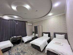 a room with three beds and a round ceiling at Hotel Shosh Boutique in Tashkent
