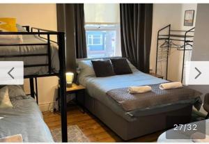 a bedroom with two bunk beds and a window at Rooms Anfield- 5 mins from LFC in Liverpool