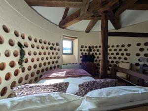 a bedroom with a bed in a room with wooden beams at Manoir Saint Joseph Colombier in Sens