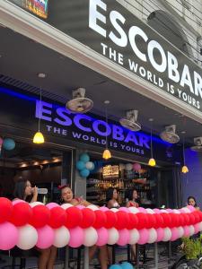 a bunch of red and white balloons in front of a store at Escobar guest house jomtien in Ban Nong Tabaek