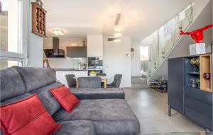a living room with a gray couch with red pillows at Lovely Home In Cartagena With Kitchen in Cartagena