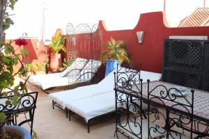 a group of beds sitting on a patio at Riad Mboja Chez Ali Baba in Marrakesh