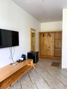 a living room with a flat screen tv on a wall at Magic Sand Beach Resort in Arambol +28 photos