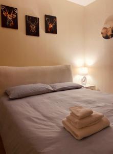 a bed with two towels sitting on top of it at La Baita in Vigo di Cadore