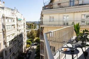 an apartment balcony with a table with food on it at Dream Luxury Apartment in the City Center by BiNoBi! in Thessaloniki