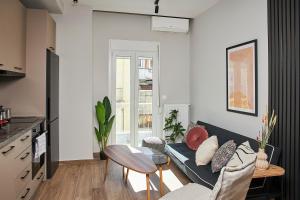 a living room with a couch and a table at Dream Luxury Apartment in the City Center by BiNoBi! in Thessaloniki