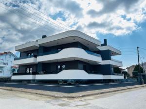 a blue and white building on the side of a street at Sunset Luxury Apartments in Keramoti