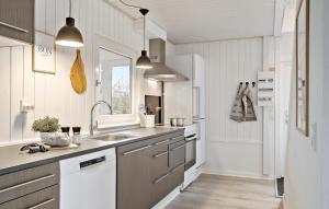 a white kitchen with a sink and a refrigerator at Amazing Home In Haderslev With Wifi in Haderslev