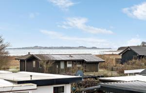 a group of houses in front of a body of water at Amazing Home In Haderslev With Wifi in Haderslev +18 photos
