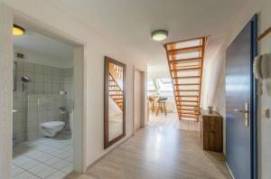 a bathroom with a shower and a toilet and a staircase at Ferienwohnung Seeblick - Ferienwohnung mit Ausblick auf den Yachthafen in Waren +12 photos