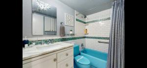 a bathroom with a sink and a blue tub at cozy family vacation spring hill ,weeki wachee in Spring Hill +7 photos