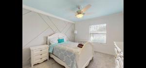 a bedroom with a bed and a ceiling fan at cozy family vacation spring hill ,weeki wachee in Spring Hill
