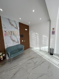 un vestíbulo con una silla azul y una puerta en Savior Deluxe Rooms, en Nápoles