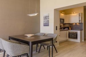 a kitchen and dining room with a table and chairs at Sonnenblume in der Seefahrtschule in Wustrow +14 photos