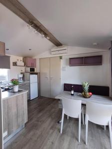 a kitchen and living room with a table and chairs at Camping Tucan - Mobile Homes by Lifestyle Holidays in Lloret de Mar