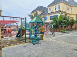 a playground with a slide and a play structure at 6A Resort LTD in Owerri