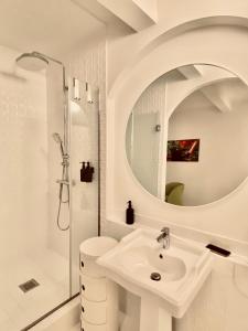 a white bathroom with a sink and a shower at DEUXMECS Porto in Porto +40 photos