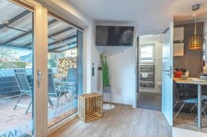 a living room with a sliding glass door leading to a patio at Ferienhaus Charlotta mit Terrasse in Waren +15 photos