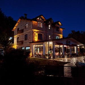 a large building with a restaurant in front of it at night at Hayat Oksijen Resort in Ordu