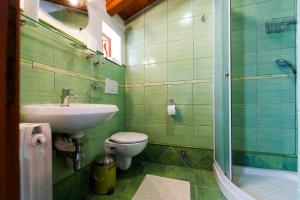 a bathroom with a sink and a toilet and a shower at Rooms Barbieri Rovinj in Rovinj