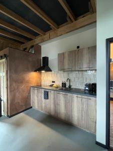 a kitchen with a sink and a counter at De Windpeluw - Daar bij die Kempermolen - Achterhoek in Breedenbroek