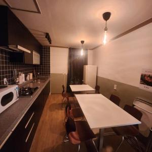 a kitchen with two tables and chairs and a refrigerator at Stay Dongdaegu in Daegu +41 photos