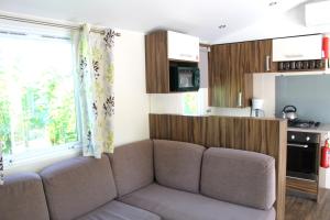 a living room with a couch in a kitchen at Camping Tucan - Mobile Homes by Lifestyle Holidays in Lloret de Mar
