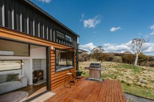 a house with a deck with a grill on it at Wildnest Wilderness in Turondale