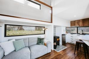 a living room with a couch and a kitchen at Wildnest Wilderness in Turondale