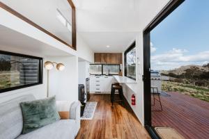 a tiny house with a kitchen and a living room at Wildnest Wilderness in Turondale +59 photos
