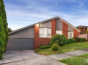 a red brick house with a garage at Villa pool garden in Melbourne