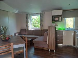 a living room with a couch and a table at Camping Tucan - Mobile Homes by Lifestyle Holidays in Lloret de Mar