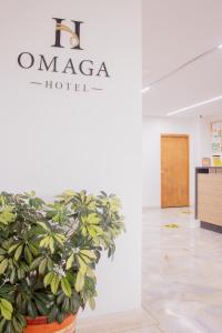 a plant in a large pot in a room at Hotel Omaga El peñol- Guatape in El Peñol