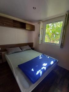 a bed in a room with a window at Camping Tucan - Mobile Homes by Lifestyle Holidays in Lloret de Mar