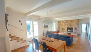 a living room with a blue couch and a table at Villa Anamour in Draguignan