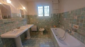 a bathroom with two sinks and a tub and a toilet at Villa Anamour in Draguignan +22 photos