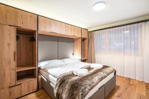 Postel nebo postele na pokoji v ubytování SWISSPEAK Resorts Thyon 4 Vallées